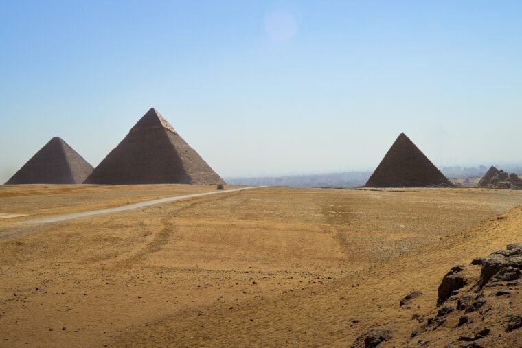 A closeup shot of a male standing and looking at Giza