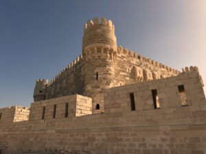 Stone walls and round tower of the Citadel of Qaitbay on the Mediterranean coast of Alexandria, Egypt