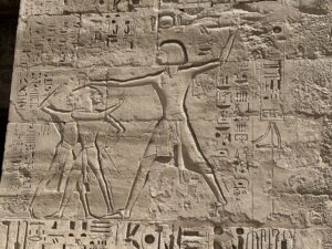 Relief of 20th-Dynasty Pharaoh Ramesses III grasping and smiting foreign captives on the first pylon of his mortuary temple at Medinet Habu in Luxor