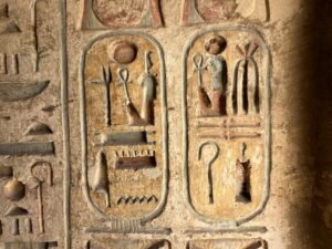 Two painted royal cartouches with hieroglyphs preserved on a temple wall at Medinet Habu