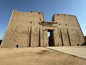 Massive entrance pylon of the Temple of Horus at Edfu, Egypt, with carved pharaonic reliefs