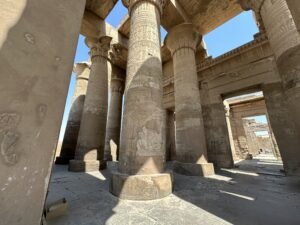 Tall hieroglyph-covered sandstone columns inside the Temple of Kom Ombo in Upper Egypt