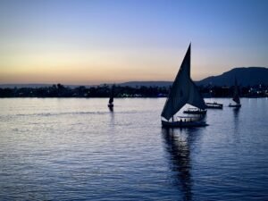 Traditional felucca sailing on the Nile River in Luxor, Egypt