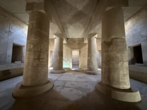 Stone chamber with carved columns and side niches inside the Temple of Seti I at Abydos, Egypt