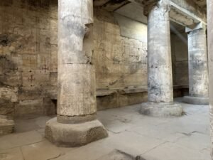 Stone columns and carved wall reliefs inside the Temple of Seti I at Abydos, Egypt