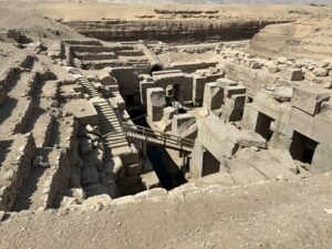 Sunken stone ruins of the Osireion at Abydos, Egypt, with massive blocks, stairs, and water channels