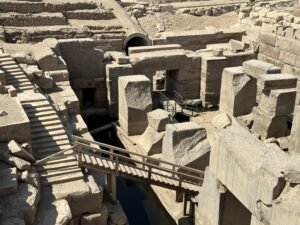 Massive rectangular stone blocks and narrow footbridges inside the Osireion at Abydos, Egypt
