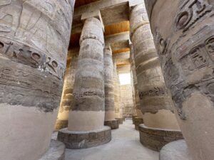 Massive hieroglyph-covered columns inside the Great Hypostyle Hall at Karnak Temple