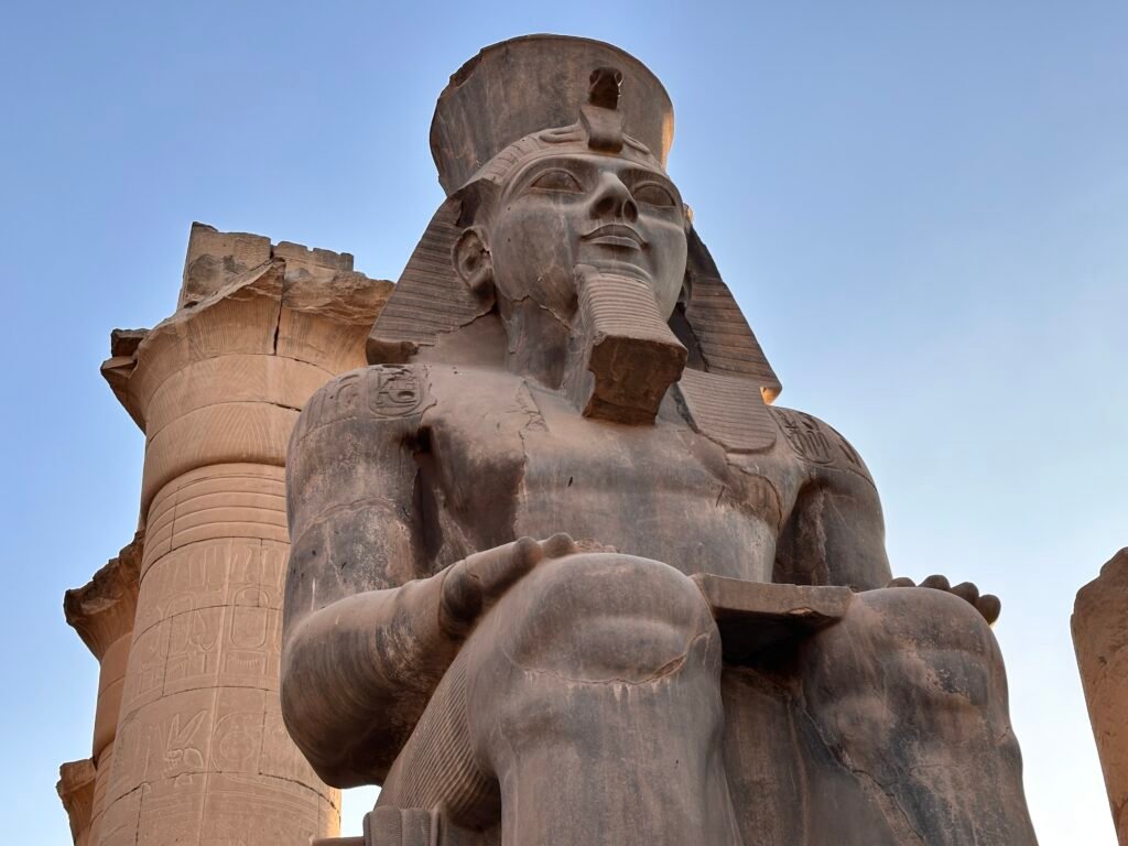 Colossal seated statue of Pharaoh Ramesses II at Luxor Temple, illustrating the later Ramesside setting often associated with alternative Exodus chronologies