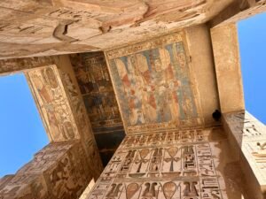 Painted ceiling panels, winged deities, hieroglyphs and ritual reliefs in the pronaos of the Temple of Horus at Edfu in Upper Egypt