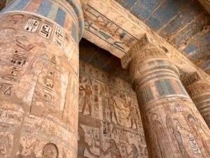 Painted Ptolemaic columns, ritual scenes and surviving blue ceiling decoration in the pronaos of the Temple of Horus at Edfu in Upper Egypt