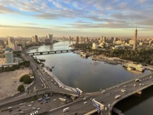 Sunrise over Cairo, Egypt, with the Nile River and city skyline in warm morning light