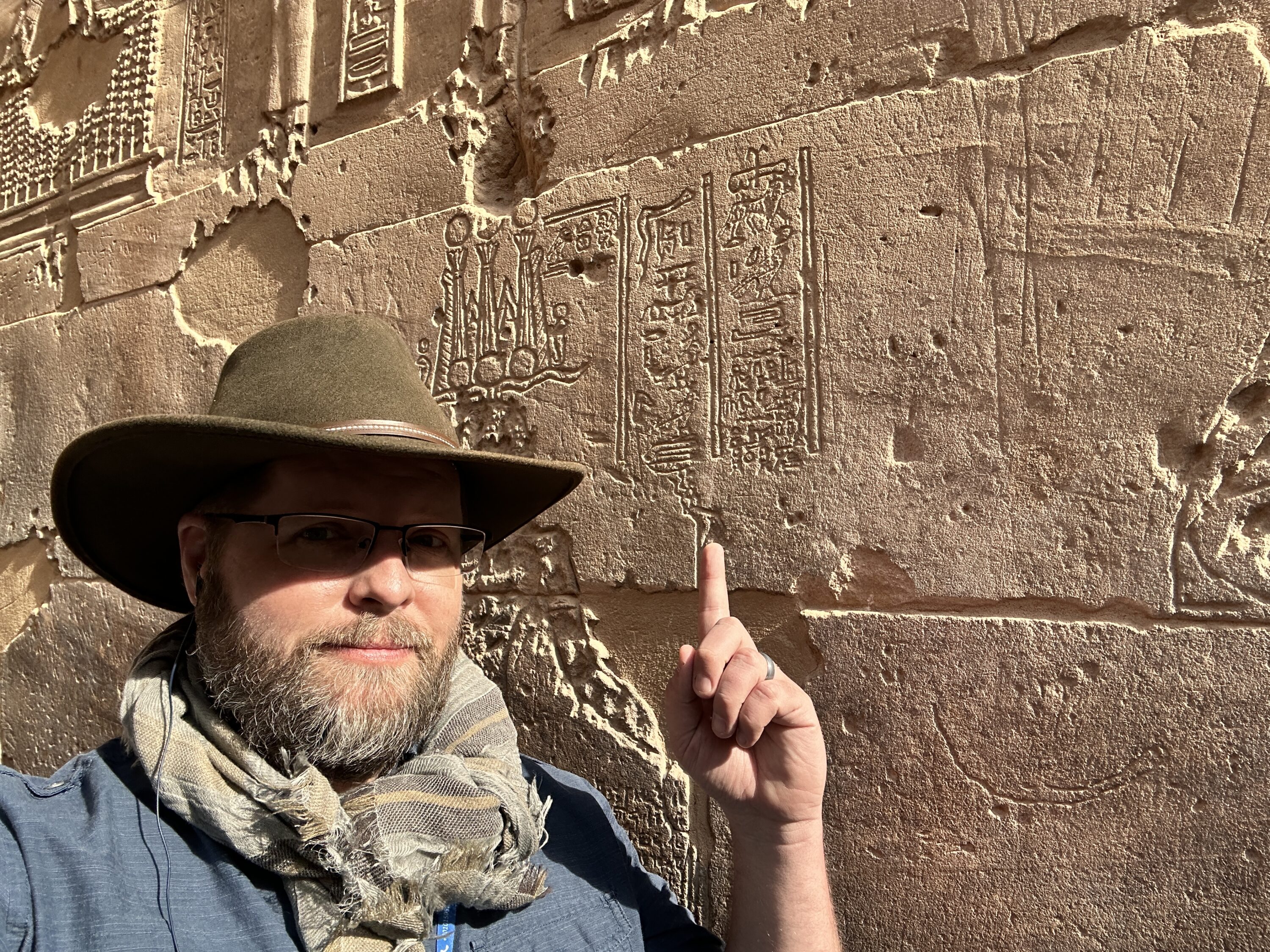 Nate Loper pointing to the last known dated hieroglyphic inscription at Philae Temple in Aswan