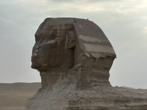 Side profile of the weathered head and nemes headdress of the Great Sphinx on the Giza Plateau