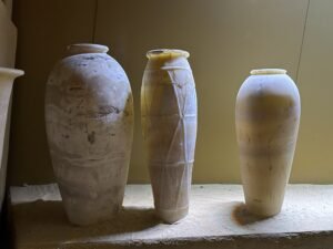 Three tall ancient Egyptian calcite vessels, traditionally called Egyptian alabaster, displayed together in the Egyptian Museum in Cairo