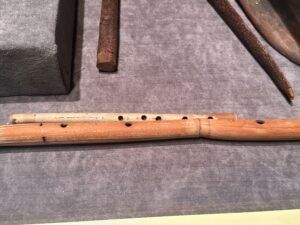 Ancient Egyptian reed flutes with finger holes displayed among wind instruments in the Egyptian Museum in Cairo