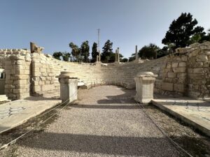 Semicircular marble seating of the Roman amphitheater at Kom el-Dikka in Alexandria, Egypt, with surviving columns and mosaic floors beside the orchestra