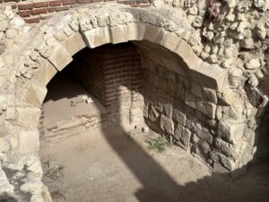 Low stone-and-brick vaulted passage within the excavated Roman archaeological complex at Kom el-Dikka in Alexandria, Egypt