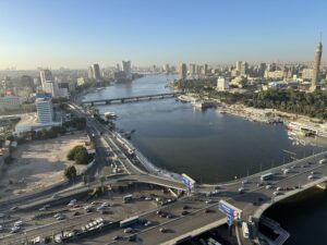 Elevated daytime view of Cairo with the Nile River, bridges, heavy traffic, and Cairo Tower