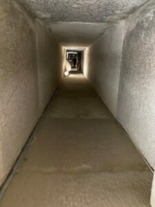 Long narrow rectangular stone passage descending through an ancient Egyptian monument