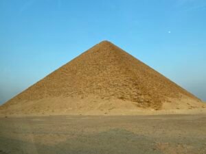 Red Pyramid of Sneferu rising from the flat desert at Dahshur beneath a clear blue sky