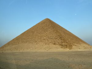 Red Pyramid of Sneferu rising from the flat desert at Dahshur beneath a clear blue sky