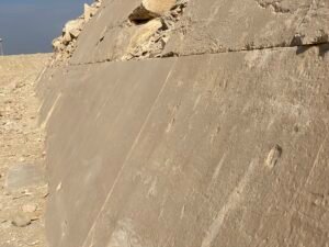 Large smooth limestone casing blocks forming an angled face on an ancient Egyptian pyramid