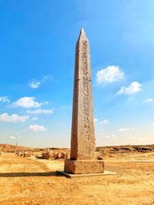 Tall inscribed ancient Egyptian obelisk standing at the archaeological site of Tanis in the eastern Nile Delta