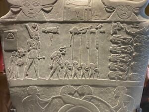 King Narmer in the Red Crown with standards and defeated enemies on the Narmer Palette, Egyptian Museum in Cairo