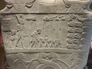 King Narmer in the Red Crown with standards and defeated enemies on the Narmer Palette, Egyptian Museum in Cairo