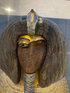 Close-up of the defaced face, gilded brow, uraeus and blue-gold inlay on the KV55 royal coffin associated with Akhenaten, JE 39627, Egyptian Museum in Cairo