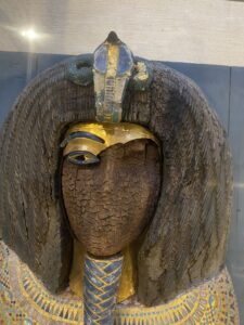 Close-up of the defaced face, gilded brow, uraeus and blue-gold inlay on the KV55 royal coffin associated with Akhenaten, JE 39627, Egyptian Museum in Cairo