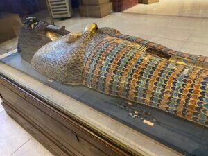 Gilded wooden KV55 royal coffin associated with Akhenaten, JE 39627, with blue-gold rishi feather decoration, crossed royal arms and defaced face, Egyptian Museum in Cairo