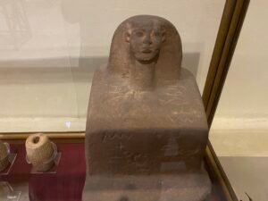 Granite block statue of Hetep, JE 48858, a 12th-Dynasty official seated in a compact block form with wig and inscriptions, from his tomb near the Teti Pyramid at Saqqara and displayed in the Egyptian Museum in Cairo