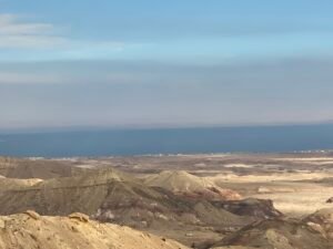 Arid layered desert hills descending toward a blue sea along Egypt’s Red Sea coast