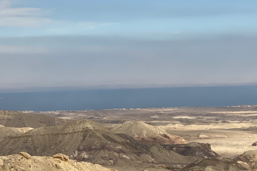 Layered desert hills descending toward the blue Red Sea coast in Egypt