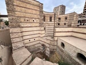 Layered stone walls and towers of the Roman fortress area in Coptic Cairo
