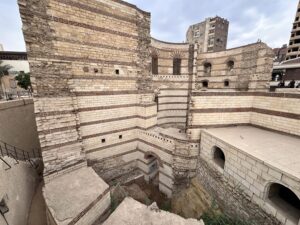 Layered stone walls and towers of the Roman fortress area in Coptic Cairo