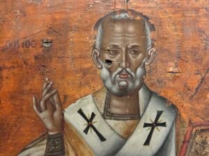 Close-up of Saint Nicholas in a 19th-century Greek icon, wearing bishop's vestments and raising his hand in blessing at the Coptic Museum in Cairo