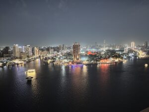 Night panorama of Cairo’s illuminated riverfront and boats on the Nile
