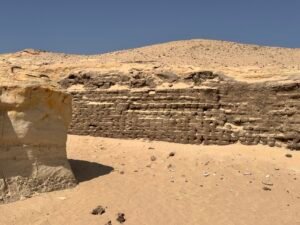 Exposed courses of ancient mudbrick in a desert wall at the Lahun archaeological site in Egypt