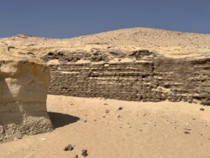 Exposed courses of ancient mudbrick in a desert wall at the Lahun archaeological site in Egypt
