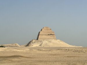 Meidum Pyramid rising above the flat desert landscape in Egypt beneath a clear sky