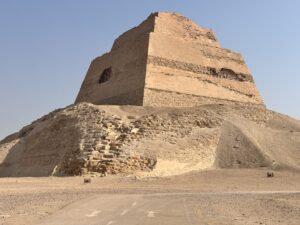 Collapsed outer layers and surviving stepped core of the Meidum Pyramid viewed from the desert in Egypt
