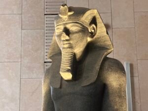 Head of the red-granite seated statue of King Amenhotep III, GEM 4607, from Thebes at the Grand Egyptian Museum in Giza