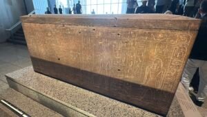 Quartzite sarcophagus of Pharaoh Thutmose I, GEM 45944, covered with hieroglyphs and funerary deities on the Grand Staircase of the Grand Egyptian Museum in Giza