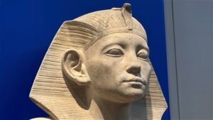 Head of the Dynasty 12 limestone seated statue of King Amenemhat III from his mortuary temple at Hawara, displayed at the Grand Egyptian Museum