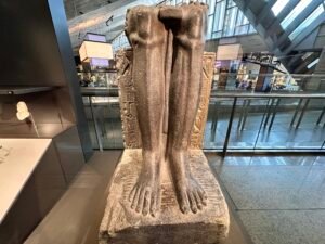 Lower portion of the granite statue of 19th-Dynasty King Merenptah as a standard bearer, GEM 2234, with royal inscriptions beside his legs, from the Temple of Amun at Tanis