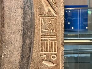 Close-up of Merenptah’s hieroglyphic royal titulary carved beside his granite standard-bearer statue, GEM 2234, Grand Egyptian Museum