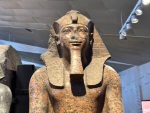 Close-up of Pharaoh Amenhotep II's face on granite statue GEM 3796 from Karnak, displayed at the Grand Egyptian Museum in Giza